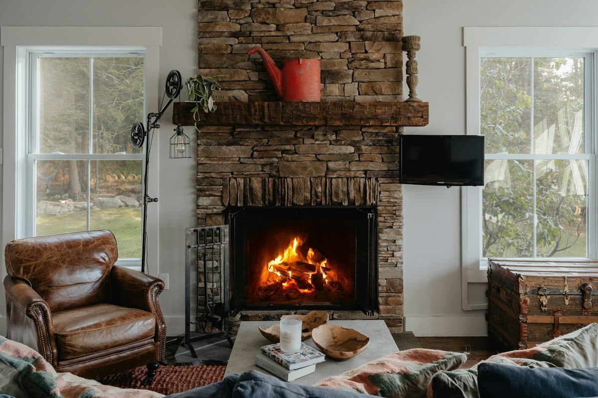 Warm, thoughtfully furnished living space with a stone fireplace